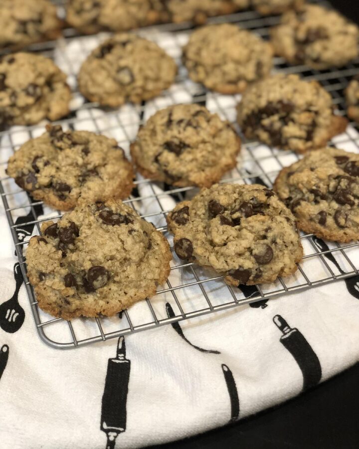Flourless Oatmeal Chocolate Chip Cookies on a cooling rack with kitchen towel in background