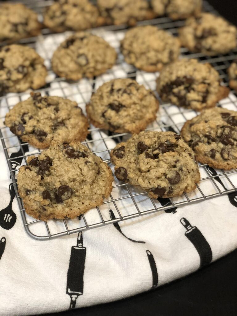 Flourless Oatmeal Chocolate Chip Cookies on a cooling rack with kitchen towel in background